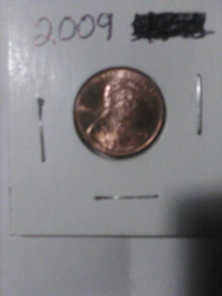 2009 us penny man sitting on log on&hellip;