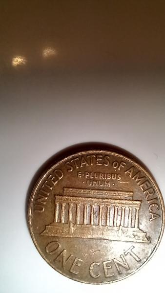 1961 penny no mint mark and L in…
