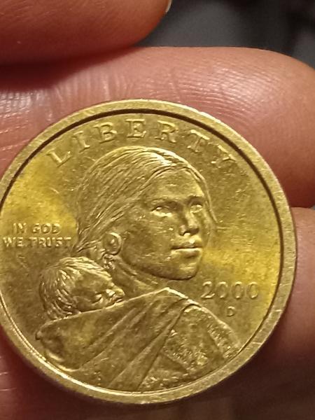 A coin2000 D Sacagawea with edge writing on…