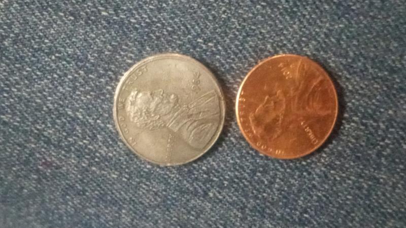 Bigger than normal penny looks like silverish
